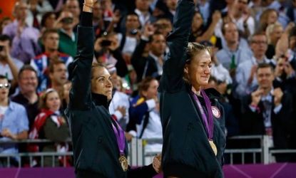 Gold medallists Misty May-Treanor and Kerri Walsh Jennings celebrate on the podium during the medal ceremony for women's beach volleyball. 