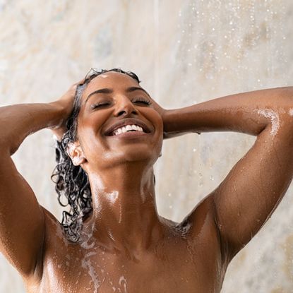 woman washing long hair in the shower