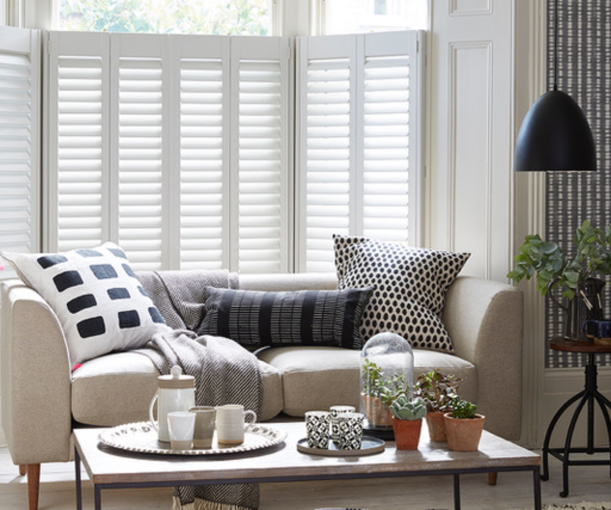white shutters tilted at living room window