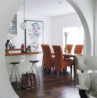 dinning room archway whit whit wall and wooden flooring