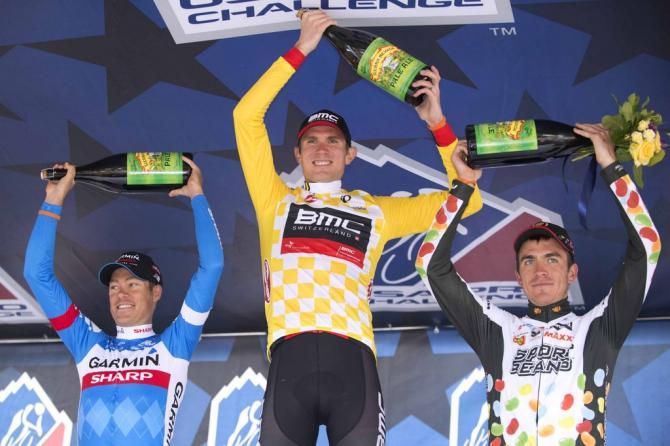 The top three raise their champagne bottles