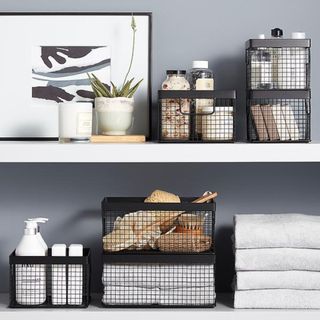 Black wire baskets with bathroom items inside