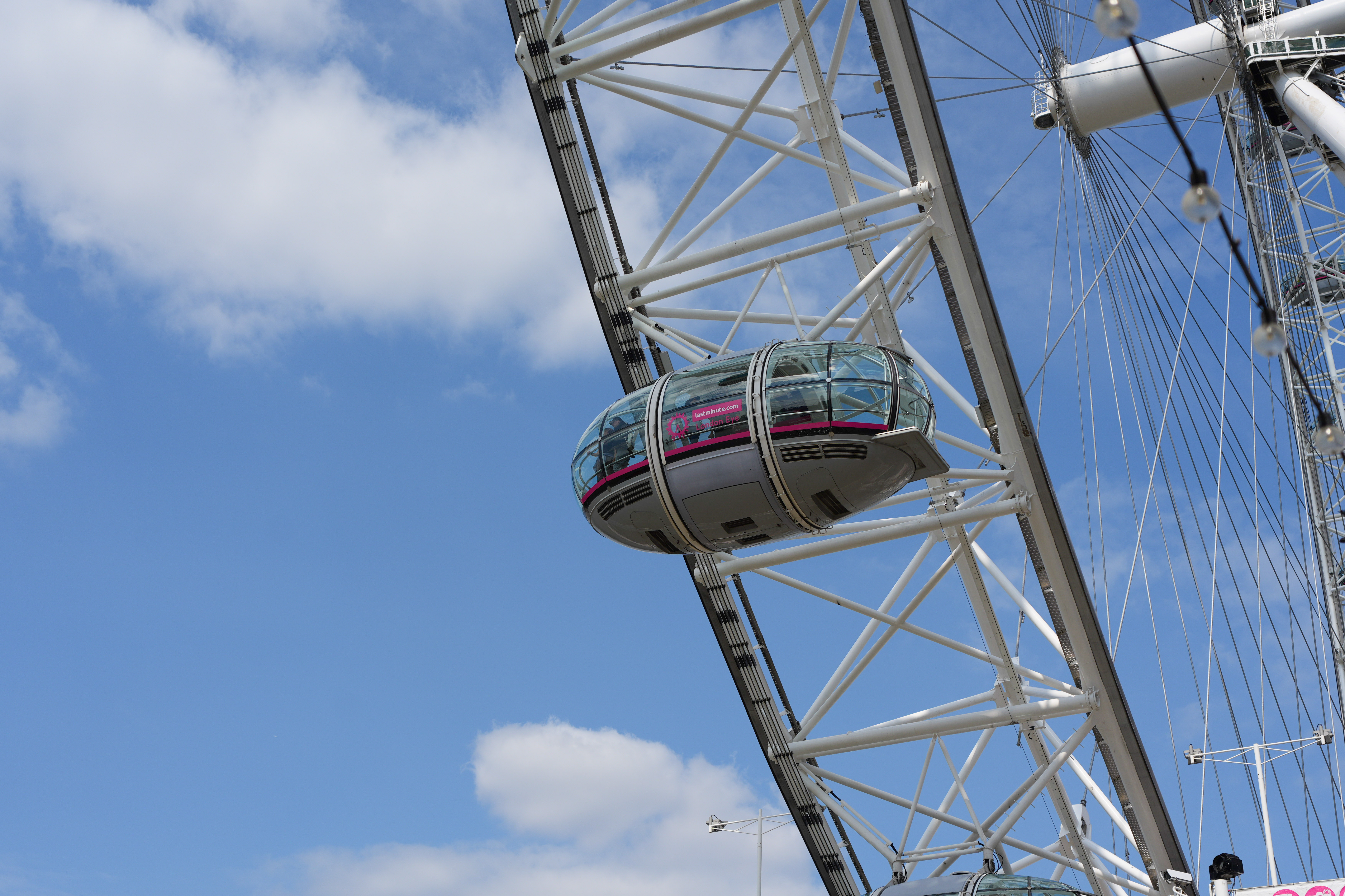A pod on the London Eye in front of a blue sky