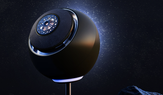 Creative Pebble Nova speaker illuminated to look like a comet on starry sky backdrop