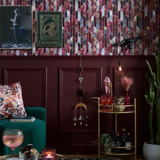 Patterned wallpaper and wall panelling in burgundy living room