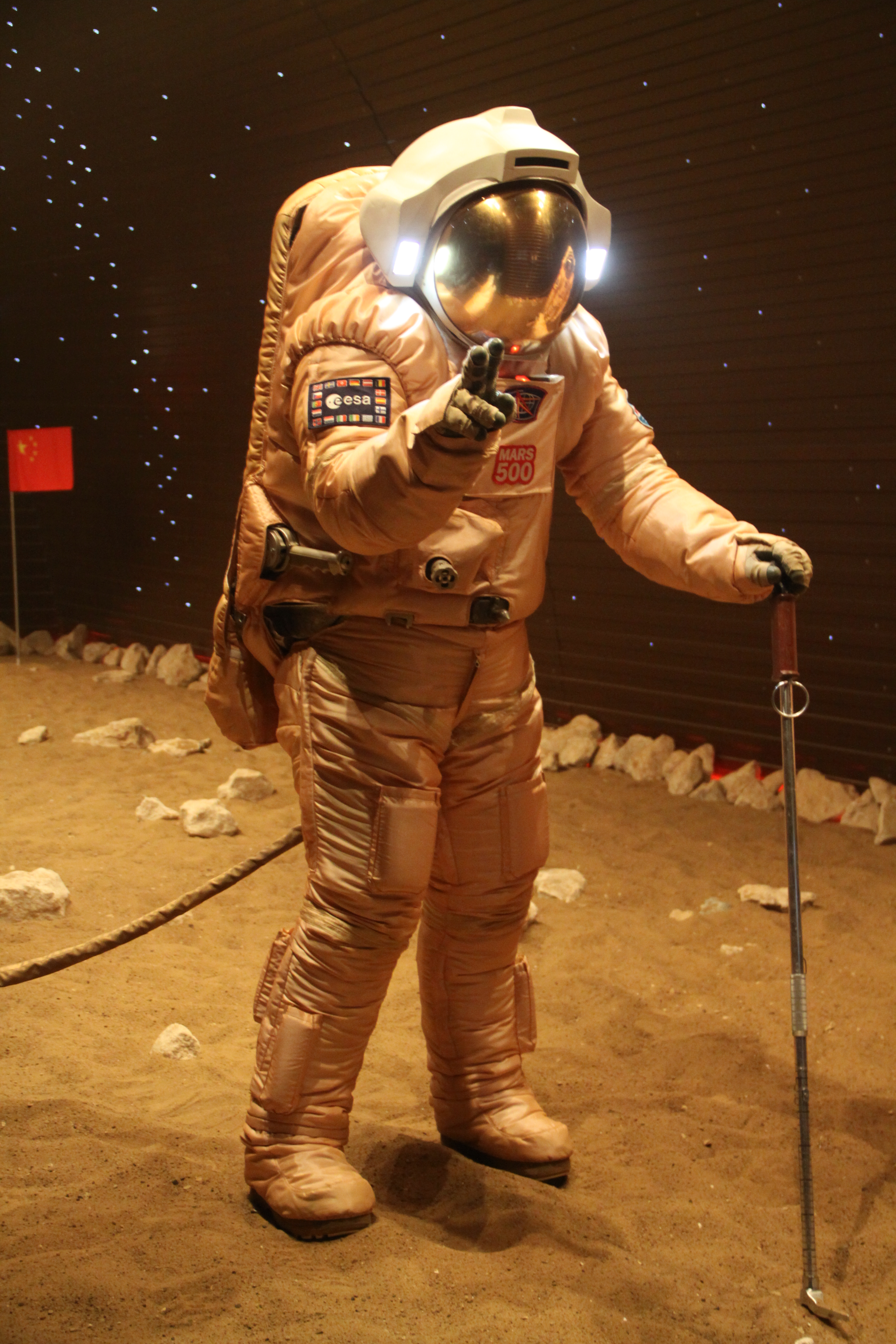 Mars500 astronaut Diego Urbina treks across simulated Martian terrain. Urbina is carrying a tool originally designed for Soviet manned lunar missions in the 1960s and 1970s that never came to pass. 