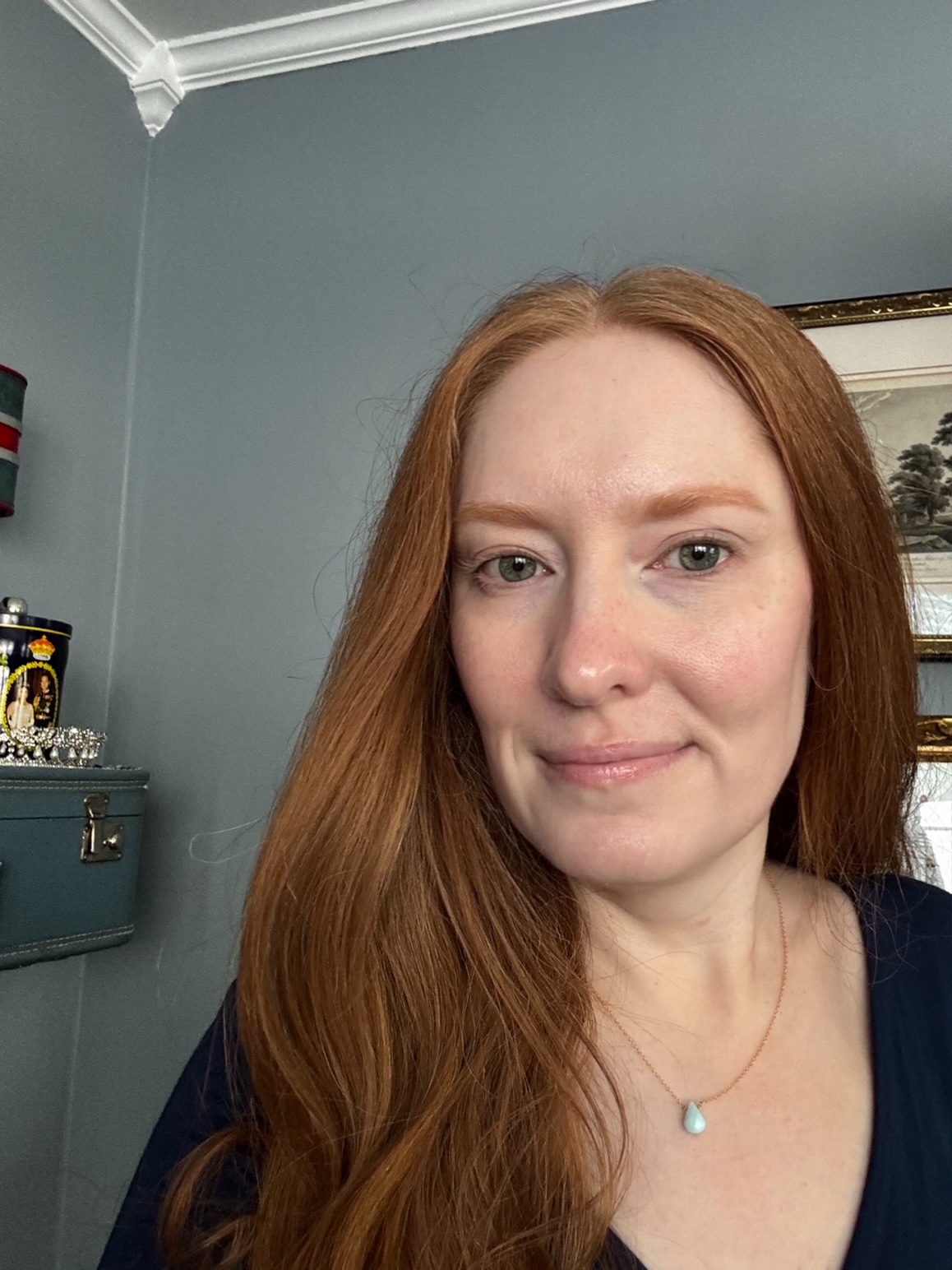 A selfie of Kristin Contino wearing a blue dress smiling at the camera