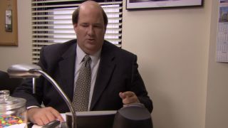 Kevin frowning at the phone in The Office