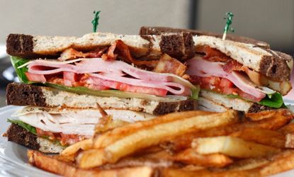 The classic, bacon-accented, three-tiered sandwich is actually an astute reflection of a city's expense.