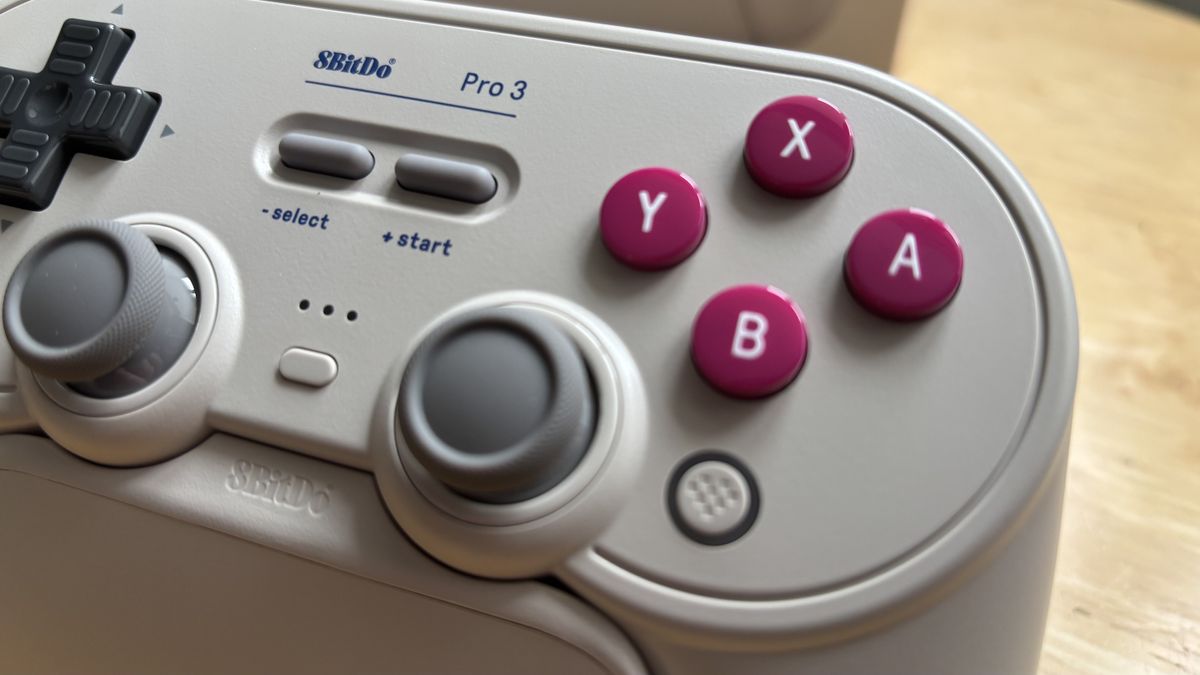 The 8BitDo Pro 3 controller photographed on a wooden table.