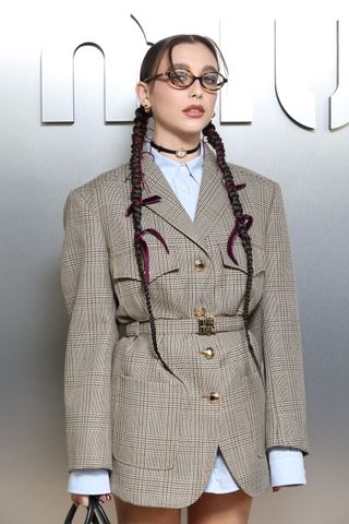 Emma Chamberlain wearing a watch choker to Miu Miu fashion week show
