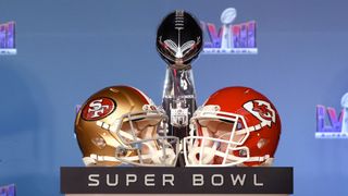 A San Francisco 49ers helmet and a Kanses City Chiefs helmet seen placed next to a Super Bowl trophy for Super Bowl 2024.