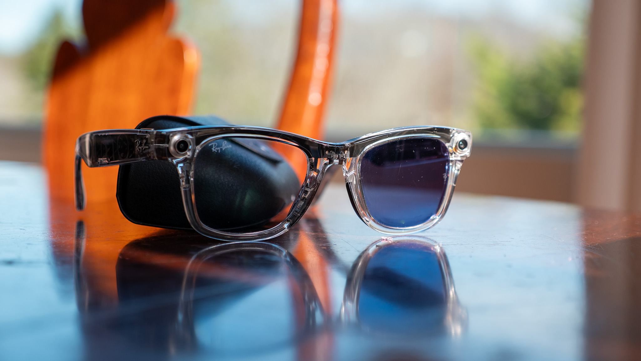 A pair of transparent Ray-Ban Meta Smart Glasses with transitions lenses on a table