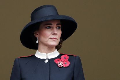 Kate Middleton wearing a wide rimmed hat and poppies.