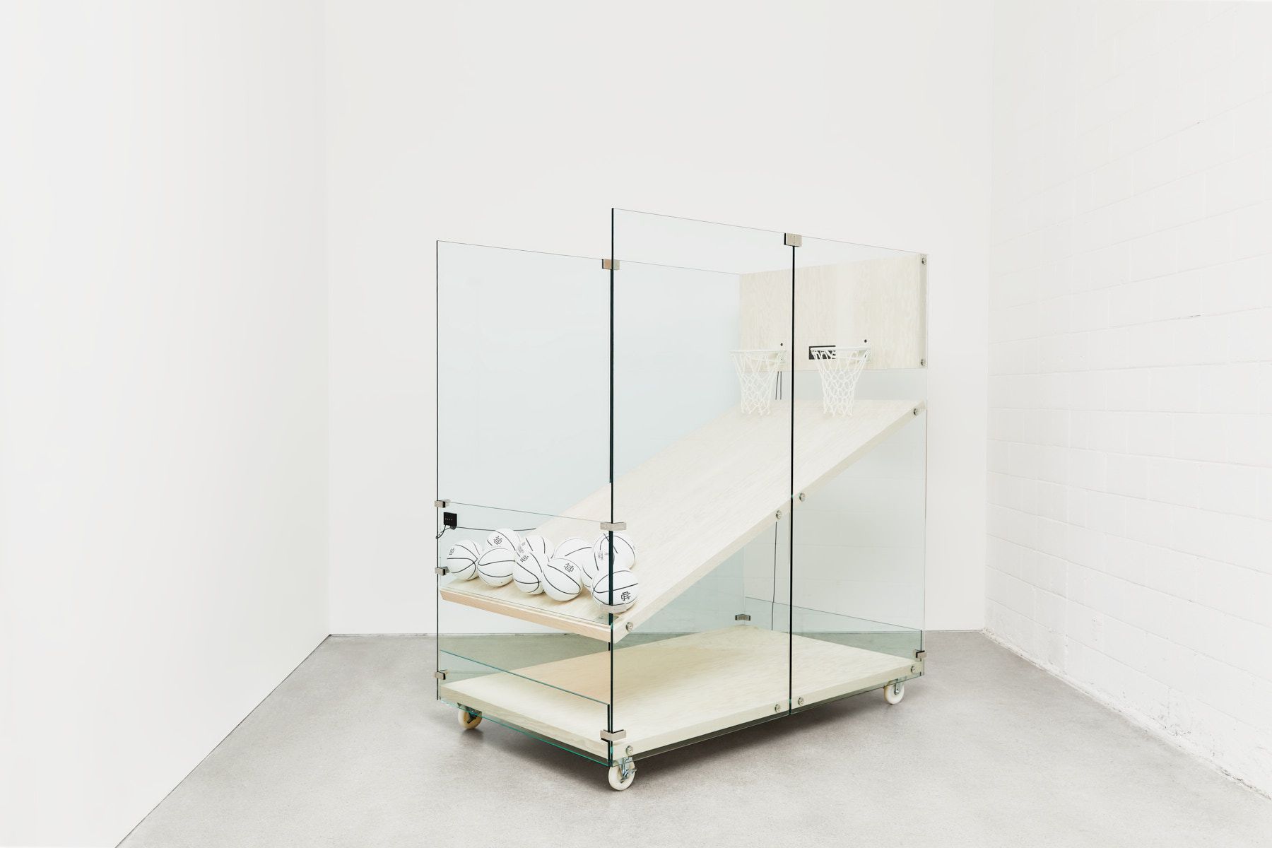 Reigning Champ basketball arcade game made of wood and glass side angle