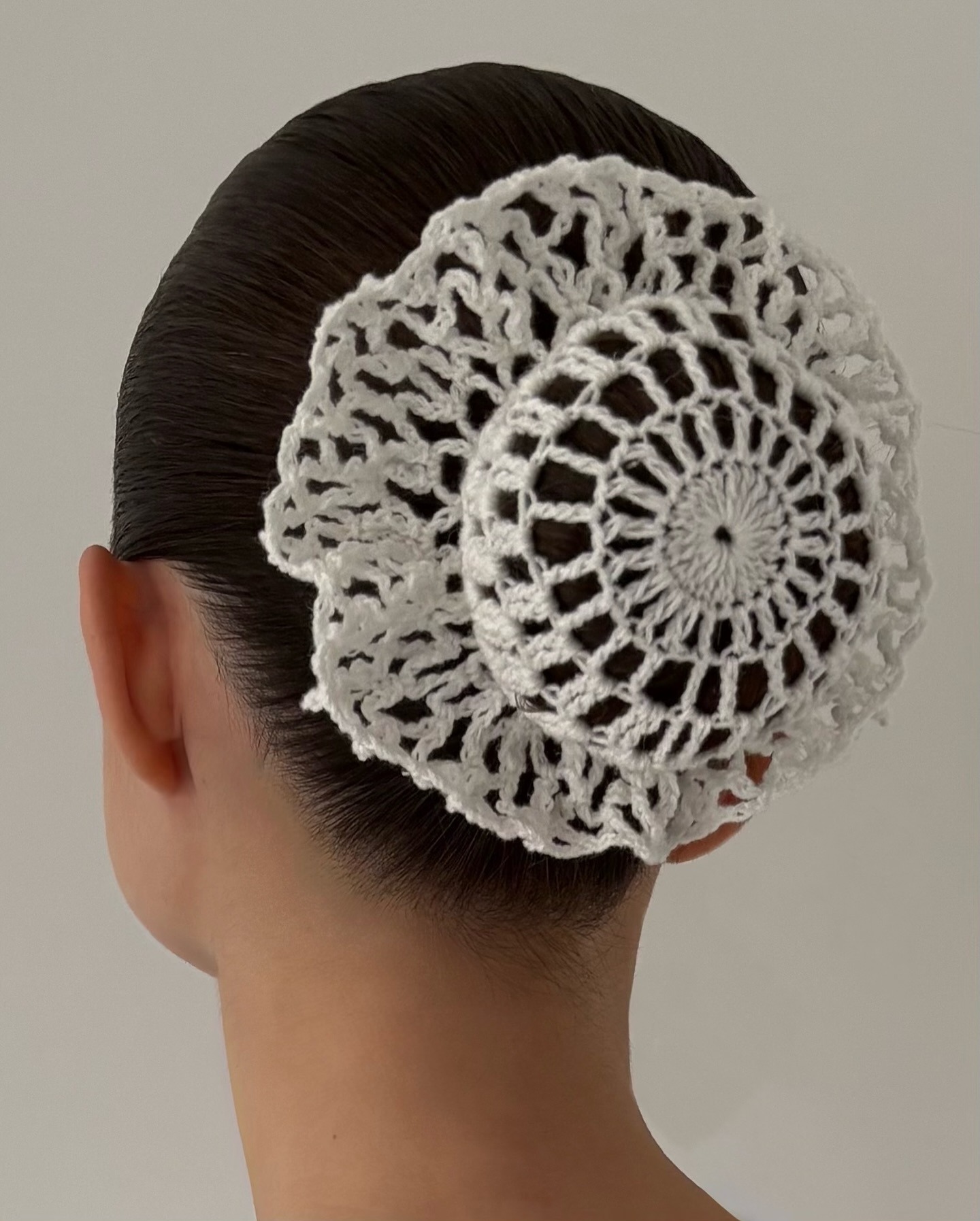 Photo of Andrea Ricci wearing a crochet bun cover