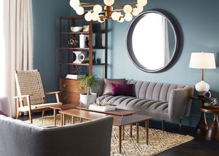 living room with large circle mirror