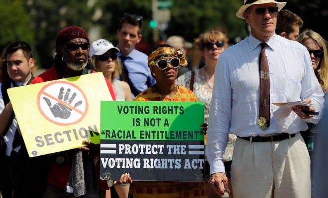 Supporters of the Voting Rights Act listen to speakers outside the U.S. Supreme Court after Tuesday&amp;#039;s ruling.