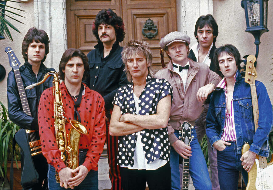 Rod Stewart with band members and their instruments at the front entrance of his North Carolwood Drive, Beverly Hills,CA.mansion in 1985