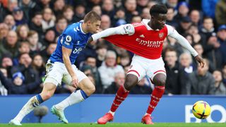 italiy Mykolenko of Everton battles for possession with Bukayo Saka of Arsenal during a Premier League match between Everton FC and Arsenal FC