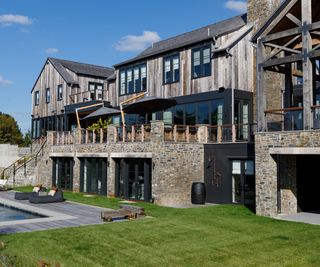 The exterior of a newly built mountain home made from reclaimed wood and quarried stone