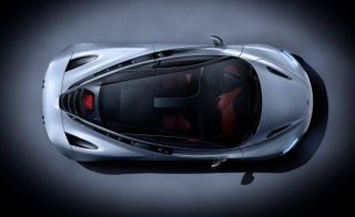 Grey McLaren 720S photographed from above against a grey background