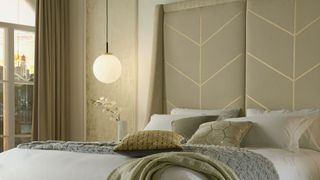 Neutral bedroom with a hotel luxe statement double height upholstered headboard