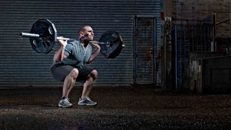 guy lighting heavy bar weight