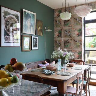 dining area with wooden table, vintage chairs, feature wall and vintage artwork and lighting