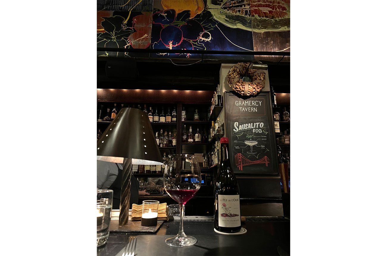 Glass and bottle on wine on bar in Gramercy Tavern, Manhattan