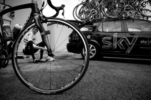 Bradley Wiggins surrounded by bikes outside the camp hotel