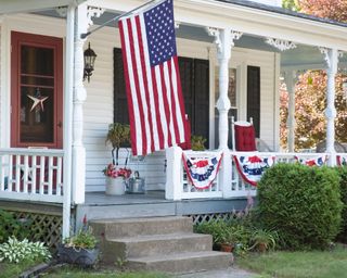 Front porch decorated with US flag