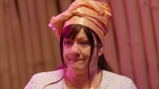 Lisa in Nigerian ceremonial dress talking to Daniel's uncle