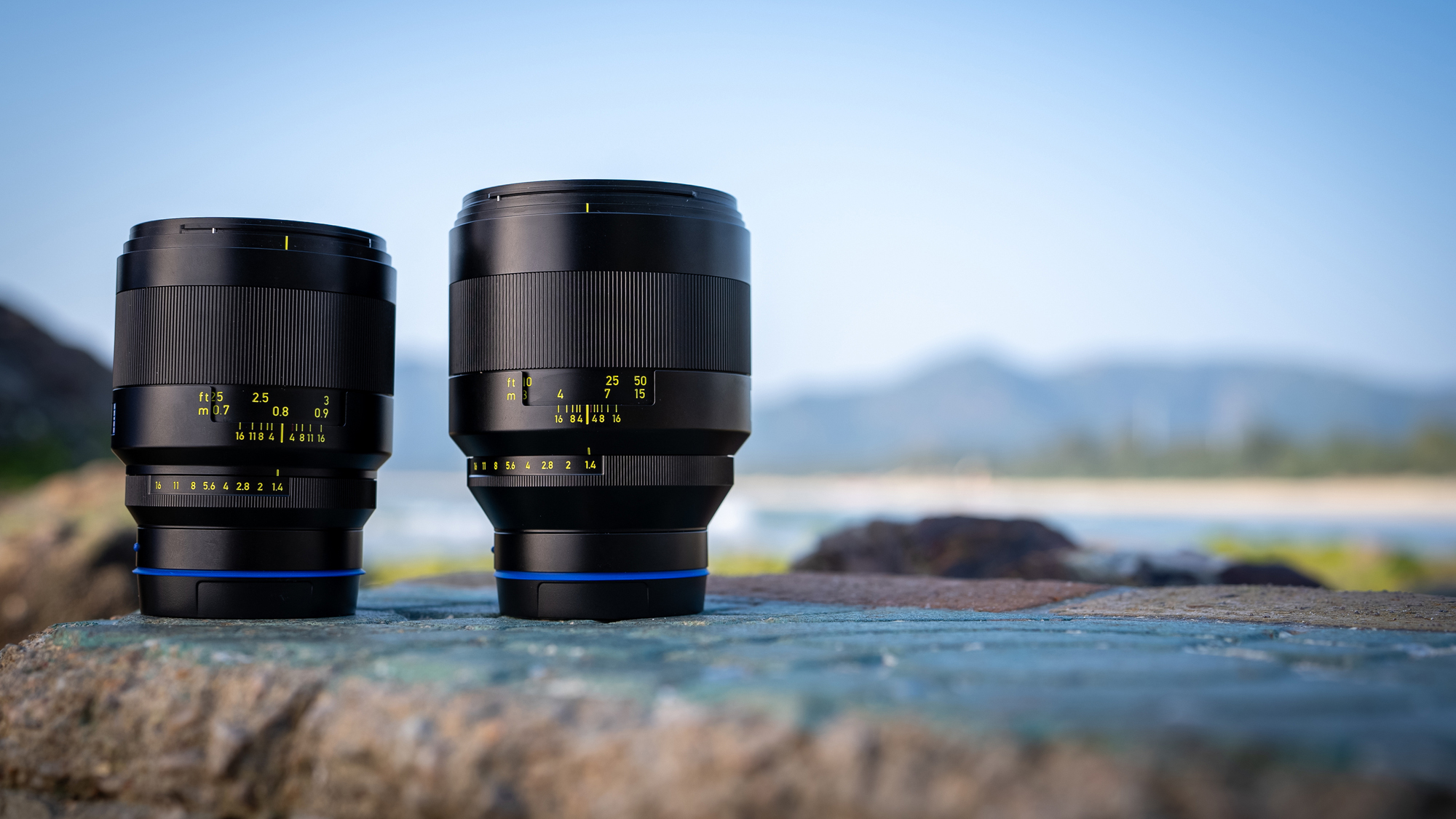 Two Zeiss lenses on a flat rock