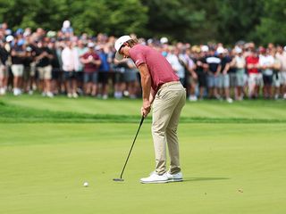 Cam Smith hitting a putt on the green