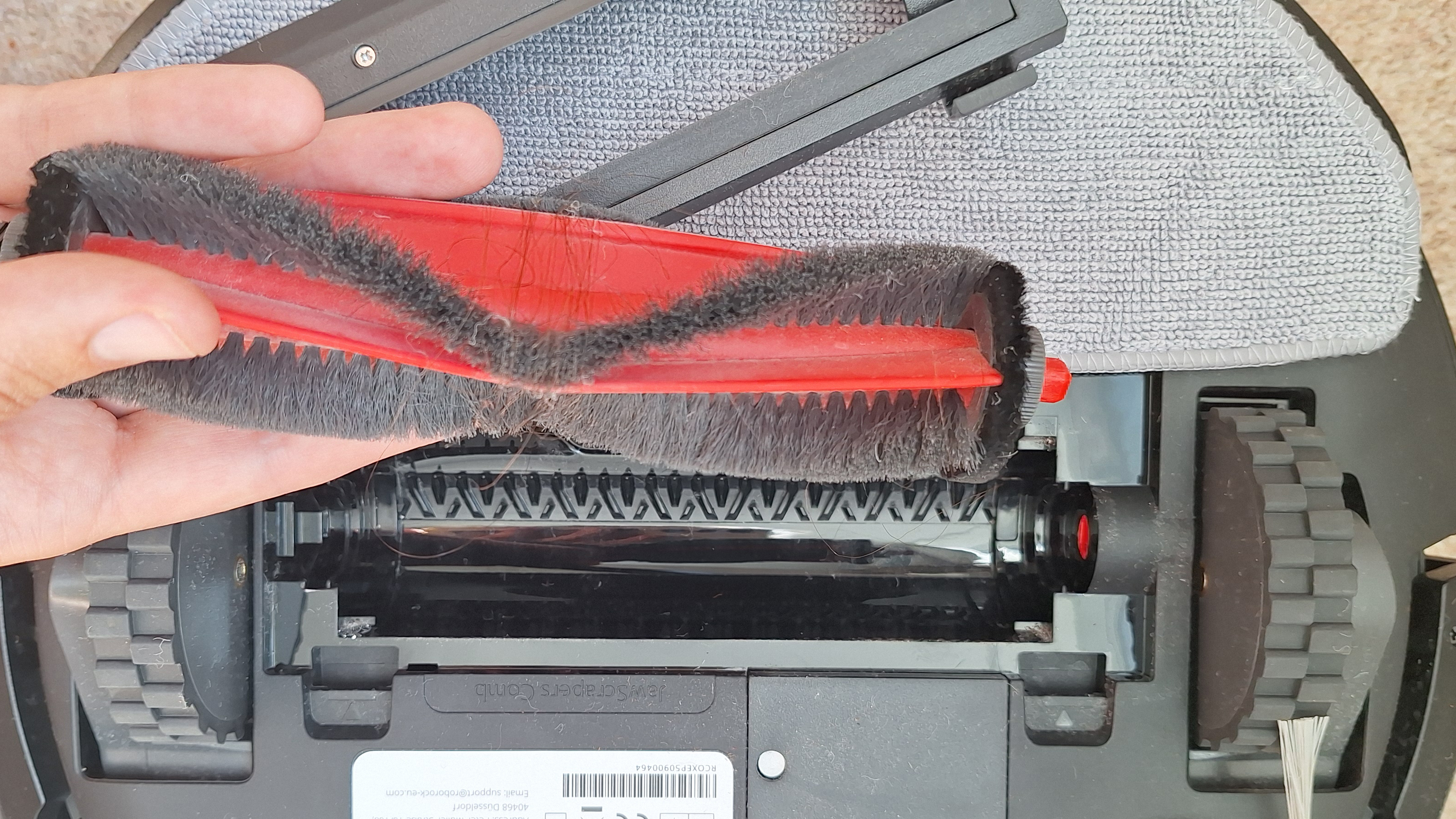 Brushroll wrapped with hair, removed from Roborock Q7 M5 robot vacuum