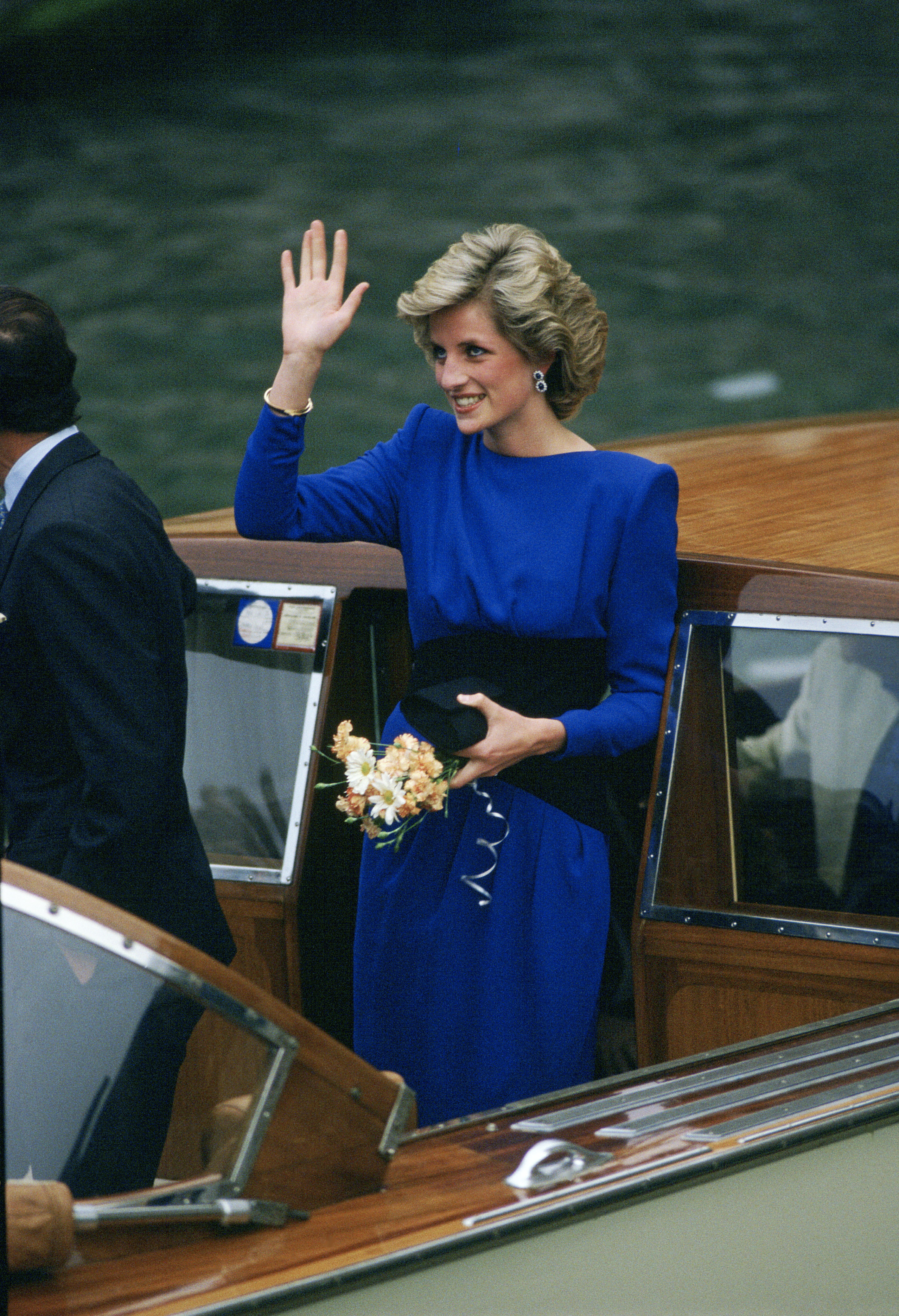 Princess Diana wearing a blue dress on a boat