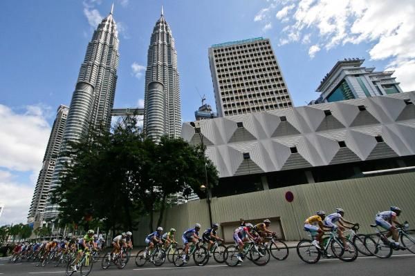 The riders pass the Petronas Towers