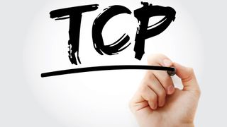 A hand writing the letters TCP