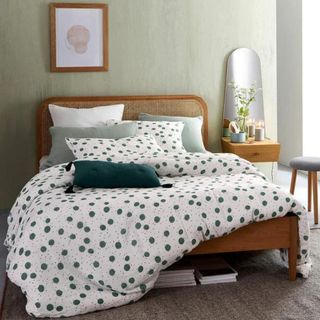 rattan bed frame with spotty bedding