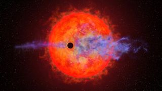 Small, black planet in front of a large, orange star. The planet's atmosphere appears to be blowing off in indigo.