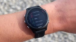 Garmin Forerunner 255 being tested on wrist, showing different sports modes