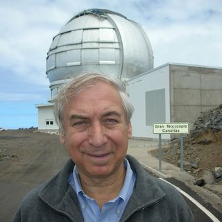 Jay Pasachoff, an astronomer at Williams College, standing in front of the largest telescope in the world, the 10.4-meter reflector in the Canary Islands.