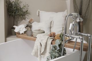 wooden bath tray styled with spa time goodies