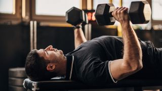 Man performing dumbbell bench press