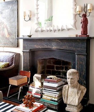 Fireplace decorated with books and antique ornaments
