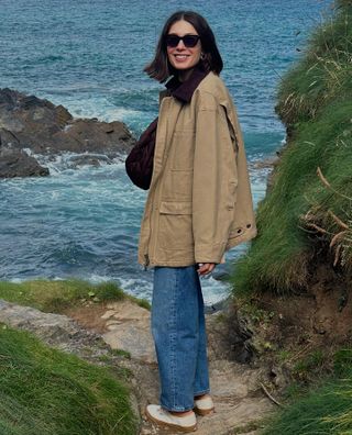 women in barn jacket and jeans