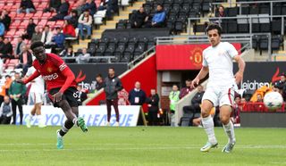 Omari Forson of Manchester United scores their sides first goal from the penalty spot during the UEFA Youth League match between Manchester United and Galatasaray A.S. at Leigh Sports Village on October 03, 2023 in Leigh, England.