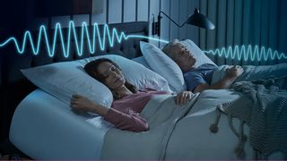 A couple in adjustable smart bed with white bedsheets and raised head position to help sleep apnea