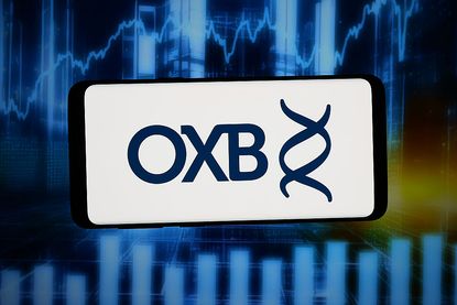 British small-cap stocks: Logo of Oxford Biomedica on a smartphone screen